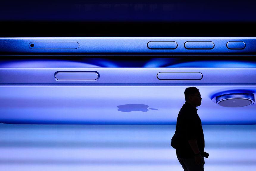 A man walks past a screen displaying the iPhone 16 inside the Apple Inc. store at Tun Razak Exchange (TRX) on September 20, 2024, in Kuala Lumpur, Malaysia.