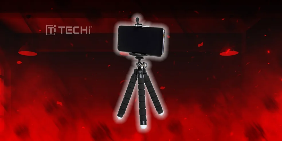 Best Cool Tech Gadgets to Own in 2025 5 Flexible smartphone tripod with mounted phone against a red glowing background.