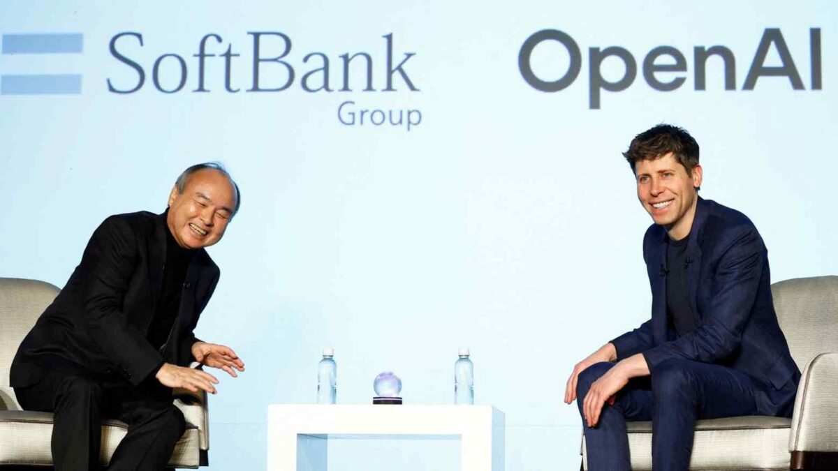 Masayoshi Son, CEO of SoftBank, sitting alongside Sam Altman, CEO of OpenAI, at an event with the SoftBank and OpenAI logos displayed in the background.